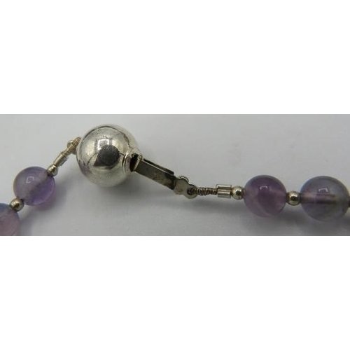 452 - A rutilated laser cut amethyst necklace with silver ball clasp and white metal spacers. Approx 18