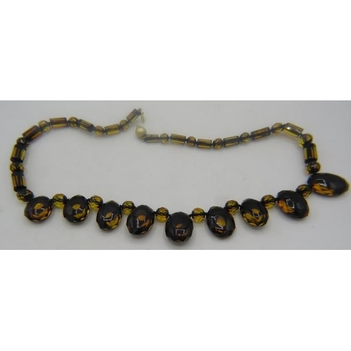 454 - A green amber necklace, found mostly in the Baltic regions, with 14ct gold ball clasp. The large amb... 