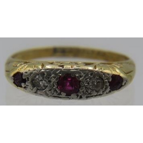 455 - An 18ct yellow gold & platinum three stone ruby & two diamond ring, size J. Centre ruby approx 2mm x... 