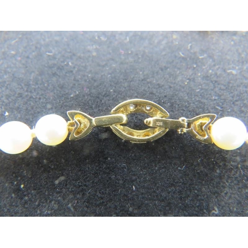 463 - A strand of Mikimoto pearls with 9ct yellow gold & diamond clasp. Interspersed with aquamarine beads... 