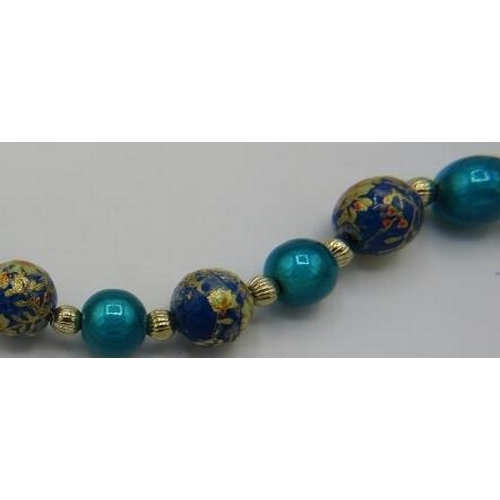 466 - A good enamelled beaded necklace strung on a fine yellow metal chain with yellow metal spacers. Appr... 