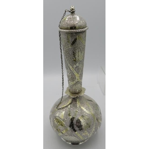 484 - A white metal Middle Eastern flask engraved with panels of leaves. Approx 11