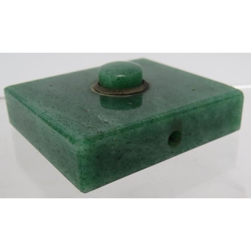 52 - An Art Deco green jade servant's bell push with brass mounts. 5cm x 45cm.
Condition report: Small ch... 