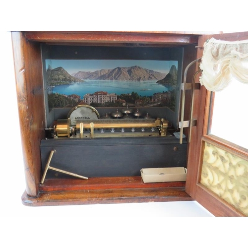 59 - A late 19th century coin operated musical box playing ten airs accompanied by six bells and a drum. ... 