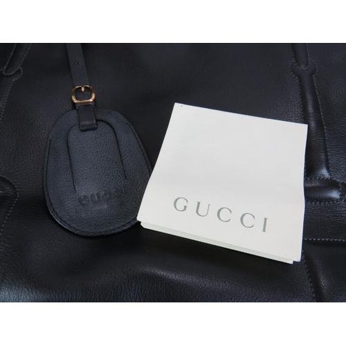 6 - A set of three Gucci graduated travel holdalls in black buttersoft leather with stitched horse bit d... 