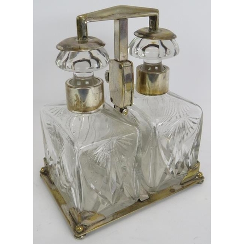 67 - A silver plated two decanter tantalus by WMF, c1930. Plated stand with key operated sprung mechanism... 