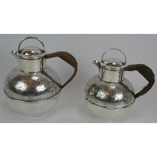 73 - A silver plated spirit kettle and stand with rattan handle, a similar teapot and two plated Jersey c... 