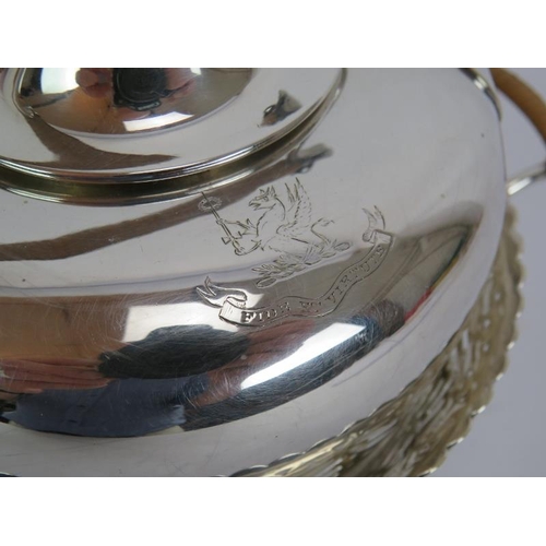 73 - A silver plated spirit kettle and stand with rattan handle, a similar teapot and two plated Jersey c... 