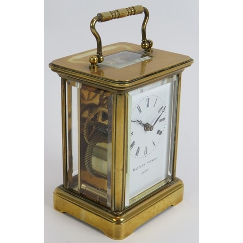 83 - A brass cased 8 day carriage clock by Matthew Norman. Eleven jewel Swiss movement. Height 14.5cm. Ke... 