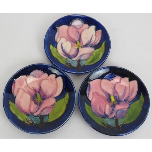 96 - Three small Moorcroft pottery dishes decorated with magnolia flowers. Each incised Moorcroft Made in... 