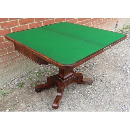 855 - A William IV rosewood turnover card table with inset green baize, featuring gadrooned edging, on a t... 