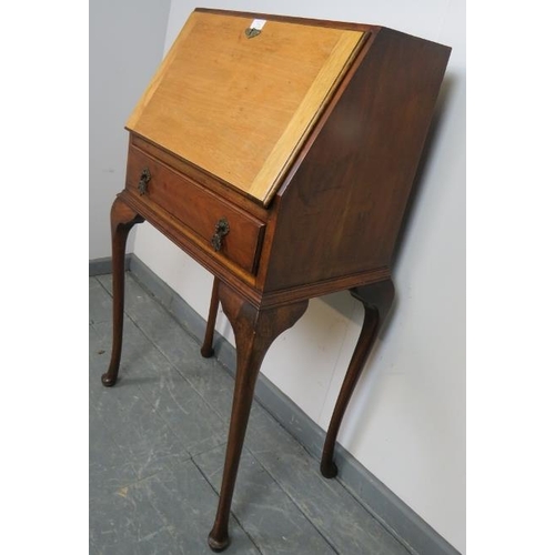 869 - A 1920s mahogany bureau, the fall front opening onto a fitted interior, over one long drawer, on cab... 