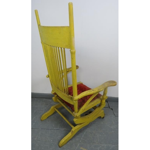 870 - A turn of the century American Arts & Crafts ‘Dexter’ rocking chair, with spindle back and shaped ar... 