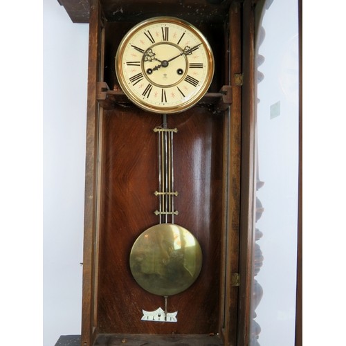 157 - A late 19th/early 20th century Continental Vienna type striking wall clock in walnut glazed case. Ke... 