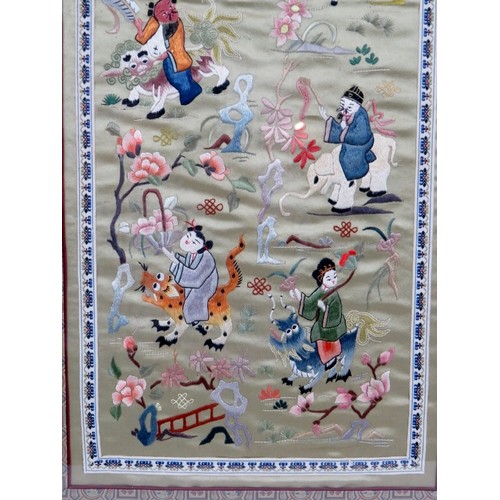 225 - A framed Chinese silkwork panel depicting various figures riding various beasts within an ornate sil... 