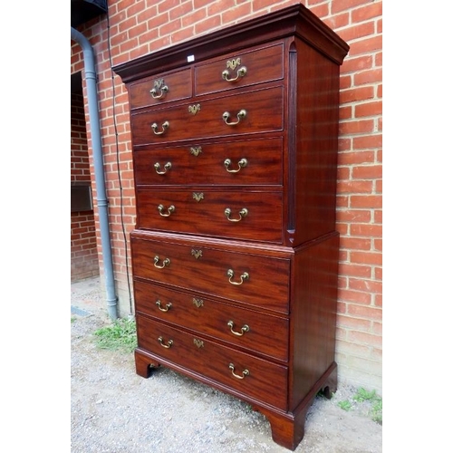 702 - A fine George III mahogany secretaire chest on chest, the top housing two short over three long grad... 