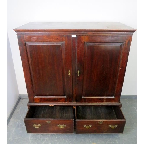 703 - An 18th century mahogany linen press of small proportions, the double doors with inset fielded panel... 