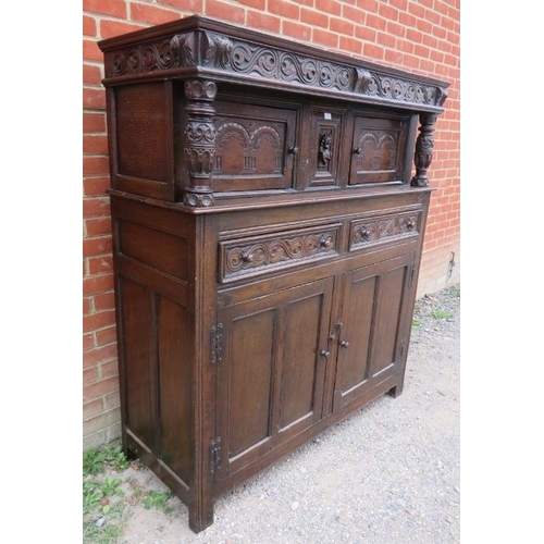 708 - A 19th century oak court cupboard in the 17th century taste, with relief carved frieze and central c... 