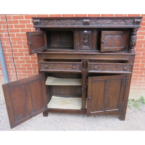 708 - A 19th century oak court cupboard in the 17th century taste, with relief carved frieze and central c... 