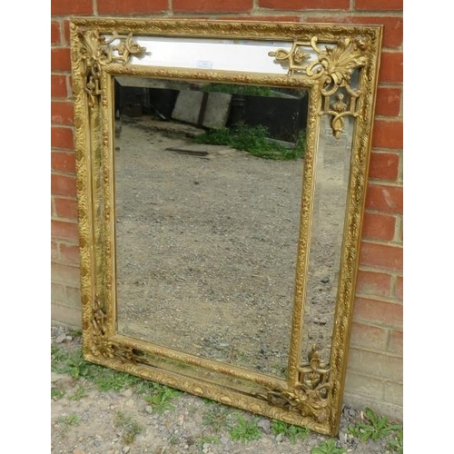 709 - A 19th century Napoleon III French cushion mirror with sectioned bevelled mirror plates, in an ornat... 