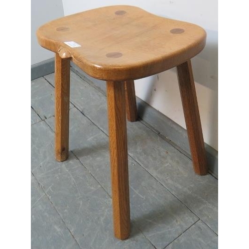 710 - A light oak stool by Mouseman, on canted octagonal supports. 
Condition report: Some varnish loss to... 