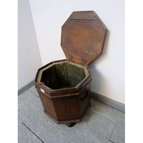 714 - An 18th century oak octagonal cellarette with tin liner and handles to either side, on bun feet. 
Co... 