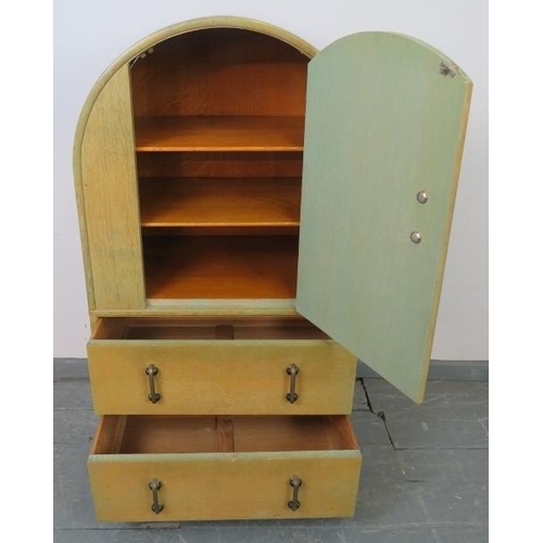 719 - An Art Deco light oak dome topped compactum, the relief carved door opening onto two fitted shelves,... 