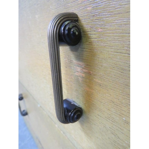 719 - An Art Deco light oak dome topped compactum, the relief carved door opening onto two fitted shelves,... 