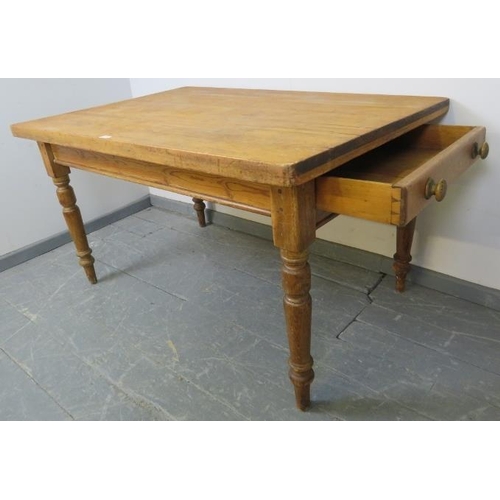 721 - An antique stripped pine scullery table, with long drawer to one end, on turned tapering supports. 
... 