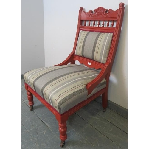 722 - An Edwardian library chair, with carved cornice, raised on tapering turned supports with ceramic cas... 