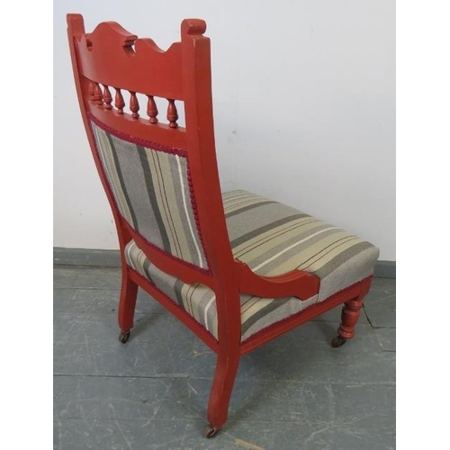 722 - An Edwardian library chair, with carved cornice, raised on tapering turned supports with ceramic cas... 