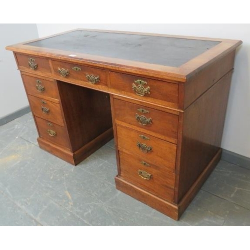 723 - A late Victorian walnut kneehole desk, with inset black rexine writing surface, the pedestals housin... 