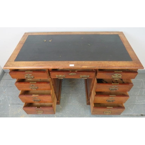 723 - A late Victorian walnut kneehole desk, with inset black rexine writing surface, the pedestals housin... 