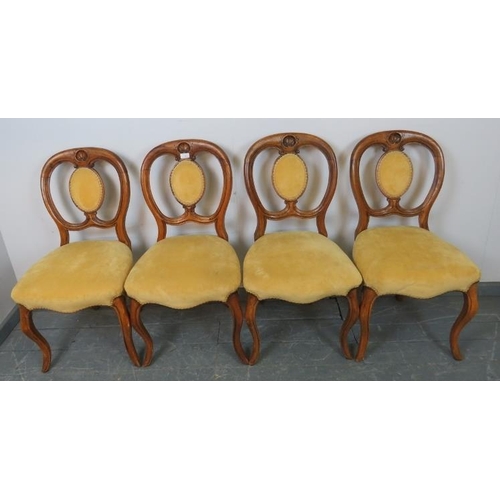 726 - A set of four Victorian walnut balloon back dining chairs, with shell carved backrests, upholstered ... 