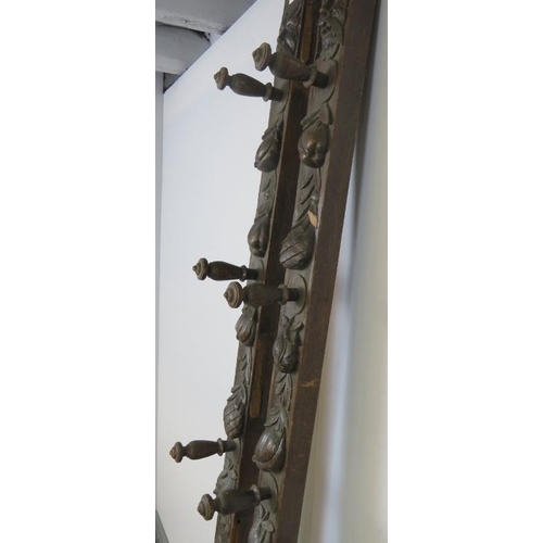 727 - A pair of 19th century oak uprights, each carved with a green man mask and depictions of fruit and f... 