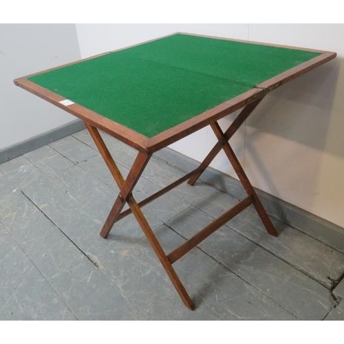 731 - A late 19th century walnut campaign card table, with inset green baize, on a folding ‘X-frame’ base ... 