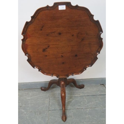 734 - A Georgian mahogany piecrust tilt-top occasional table, on a wrythen carved column with tripod base.... 