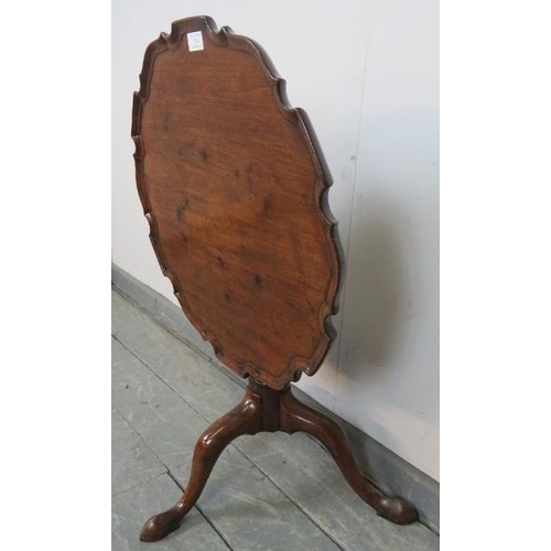 734 - A Georgian mahogany piecrust tilt-top occasional table, on a wrythen carved column with tripod base.... 