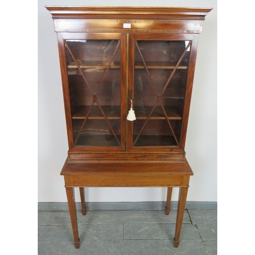 739 - An Edwardian mahogany display cabinet on stand, strung with satinwood and featuring coromandel cross... 