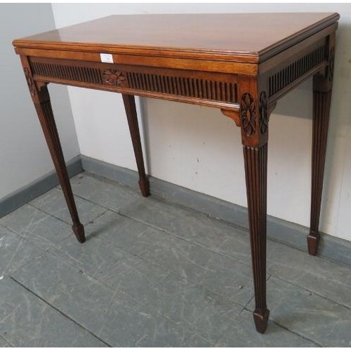 740 - An Edwardian mahogany turnover card table, with carved frieze, on tapering square reeded supports wi... 