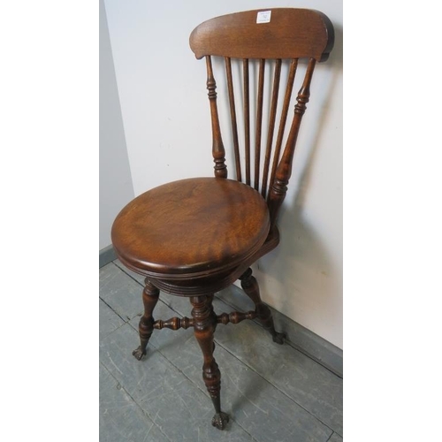 742 - A Victorian walnut cellist’s seat with spindle backrest and height adjustable seat, on turned suppor... 