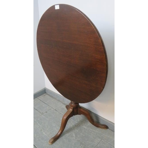 749 - A Georgian oak circular tilt top occasional table, on a tapering turned column with splayed tripod b... 