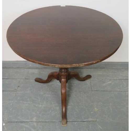 749 - A Georgian oak circular tilt top occasional table, on a tapering turned column with splayed tripod b... 