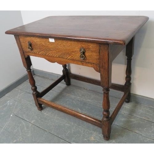 750 - A vintage oak side table in the 18th century taste, with one long oak lined frieze drawer with brass... 