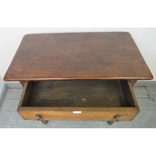 750 - A vintage oak side table in the 18th century taste, with one long oak lined frieze drawer with brass... 