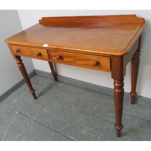 751 - A Victorian walnut writing table, with rear gallery and two short drawers with turned wooden knob ha... 