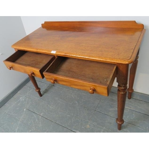 751 - A Victorian walnut writing table, with rear gallery and two short drawers with turned wooden knob ha... 