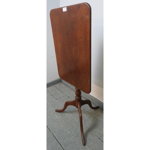 753 - A late Georgian mahogany rectangular tilt-top occasional table, on a baluster turned column with spl... 