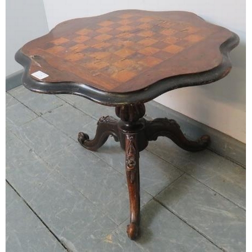 754 - A Victorian mahogany tilt-top games table with rosewood and satin walnut chessboard inlay, on a flut... 