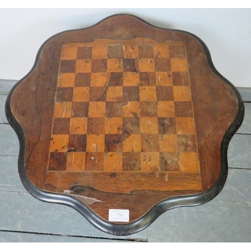 754 - A Victorian mahogany tilt-top games table with rosewood and satin walnut chessboard inlay, on a flut... 